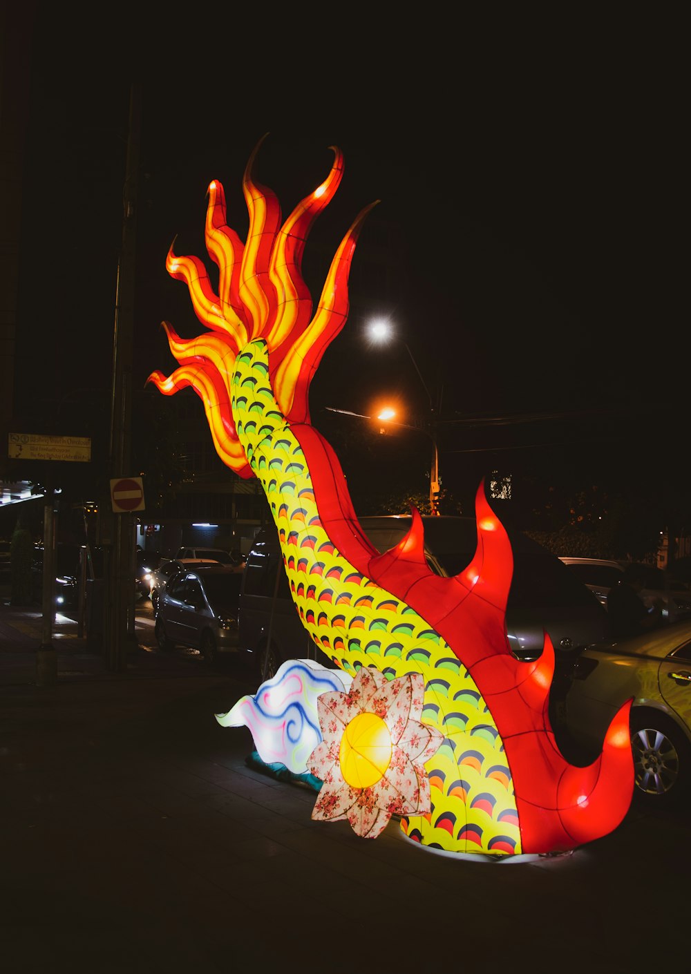 a large dragon statue sitting in the middle of a parking lot