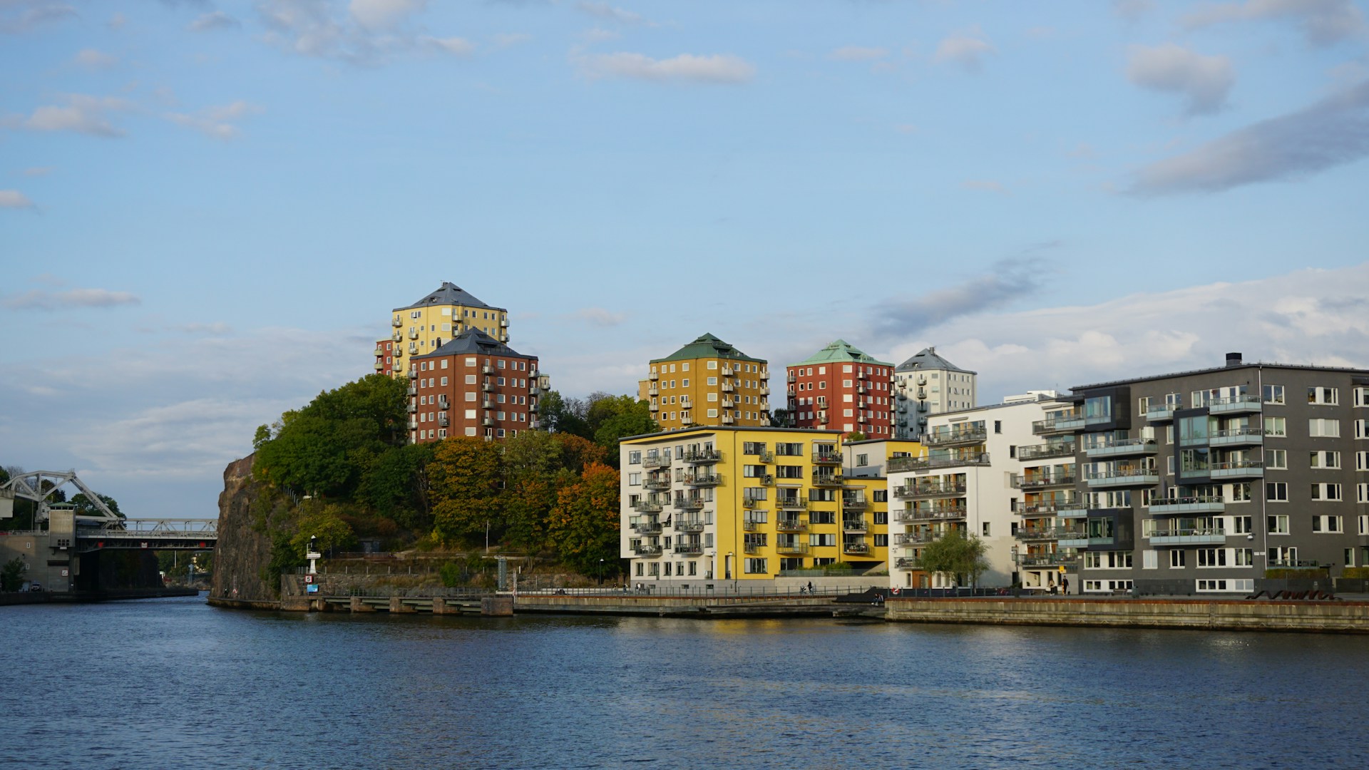 a body of water with buildings in the background