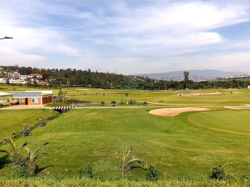 a view of a golf course from the top of a hill