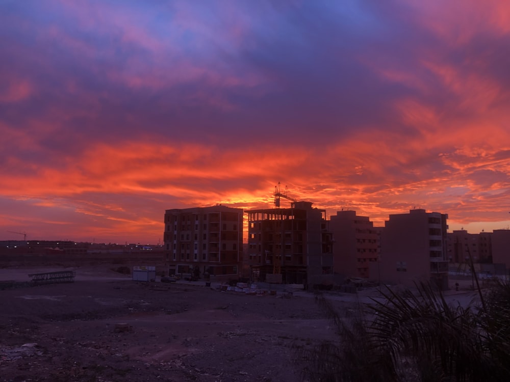 a sunset view of a city with buildings in the foreground