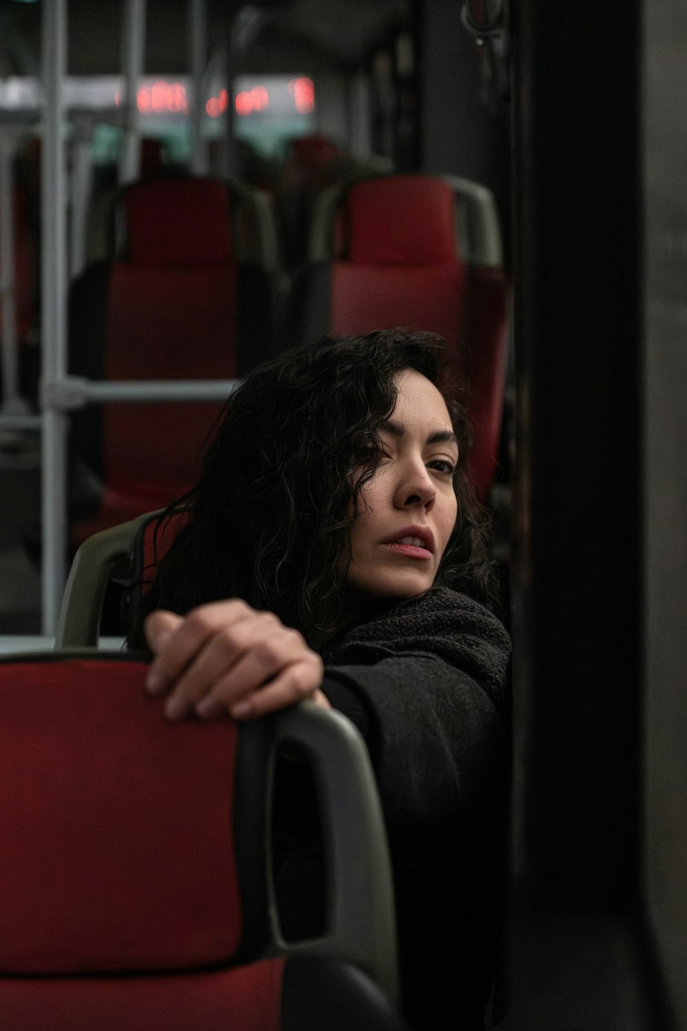 a woman sitting on a bus looking out the window