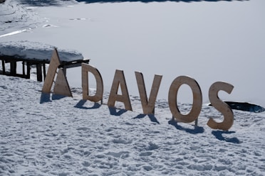 a wooden sign that reads davos in the snow