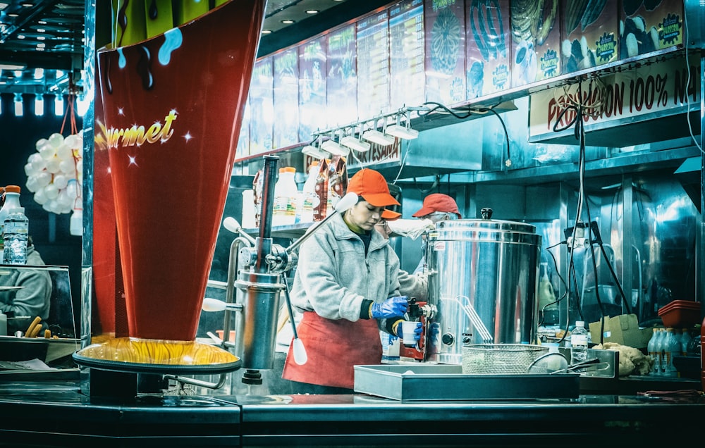 a man standing in front of a counter preparing food