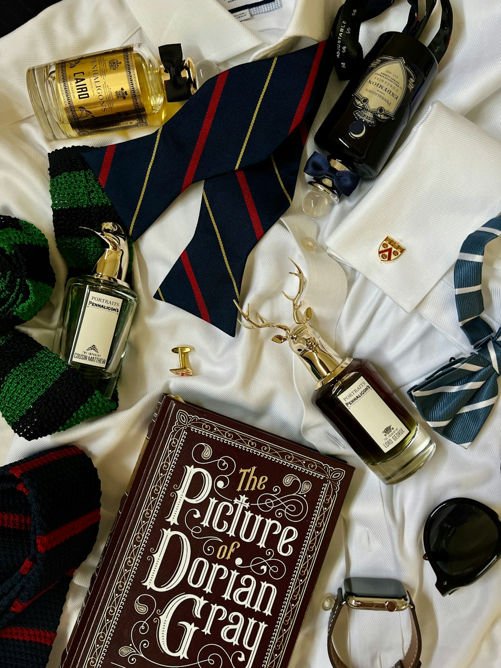 a picture of a book, tie, and other items on a bed