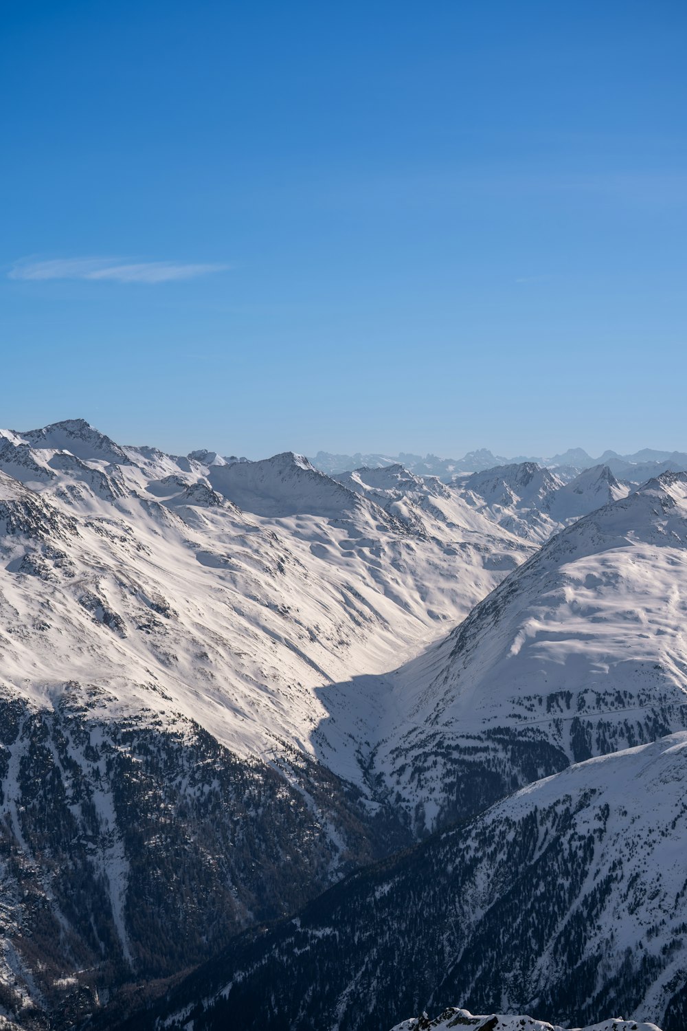 a person standing on top of a snow covered mountain