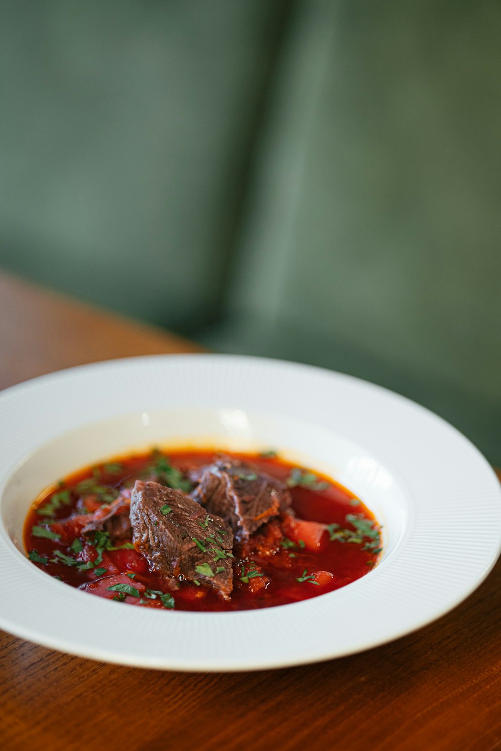 a bowl of soup on a wooden table