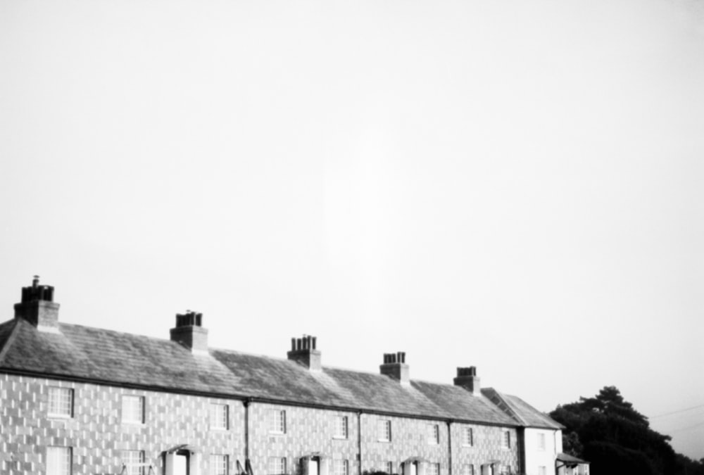 a black and white photo of a row of houses