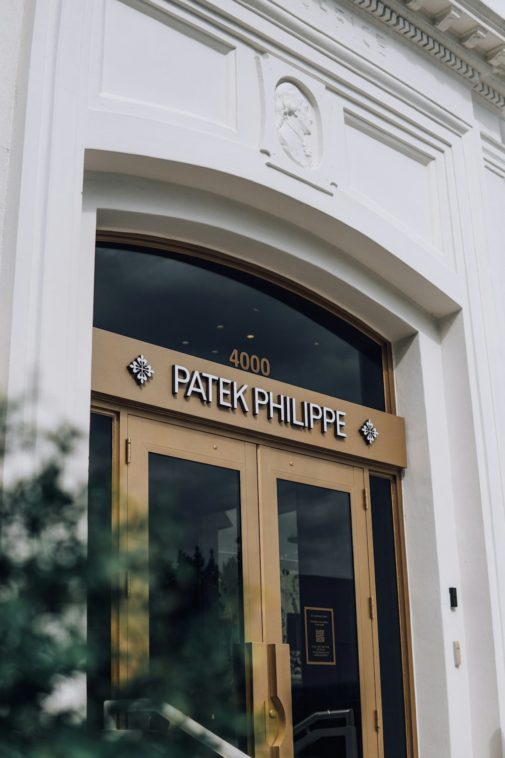 the front entrance of a building with a sign on it