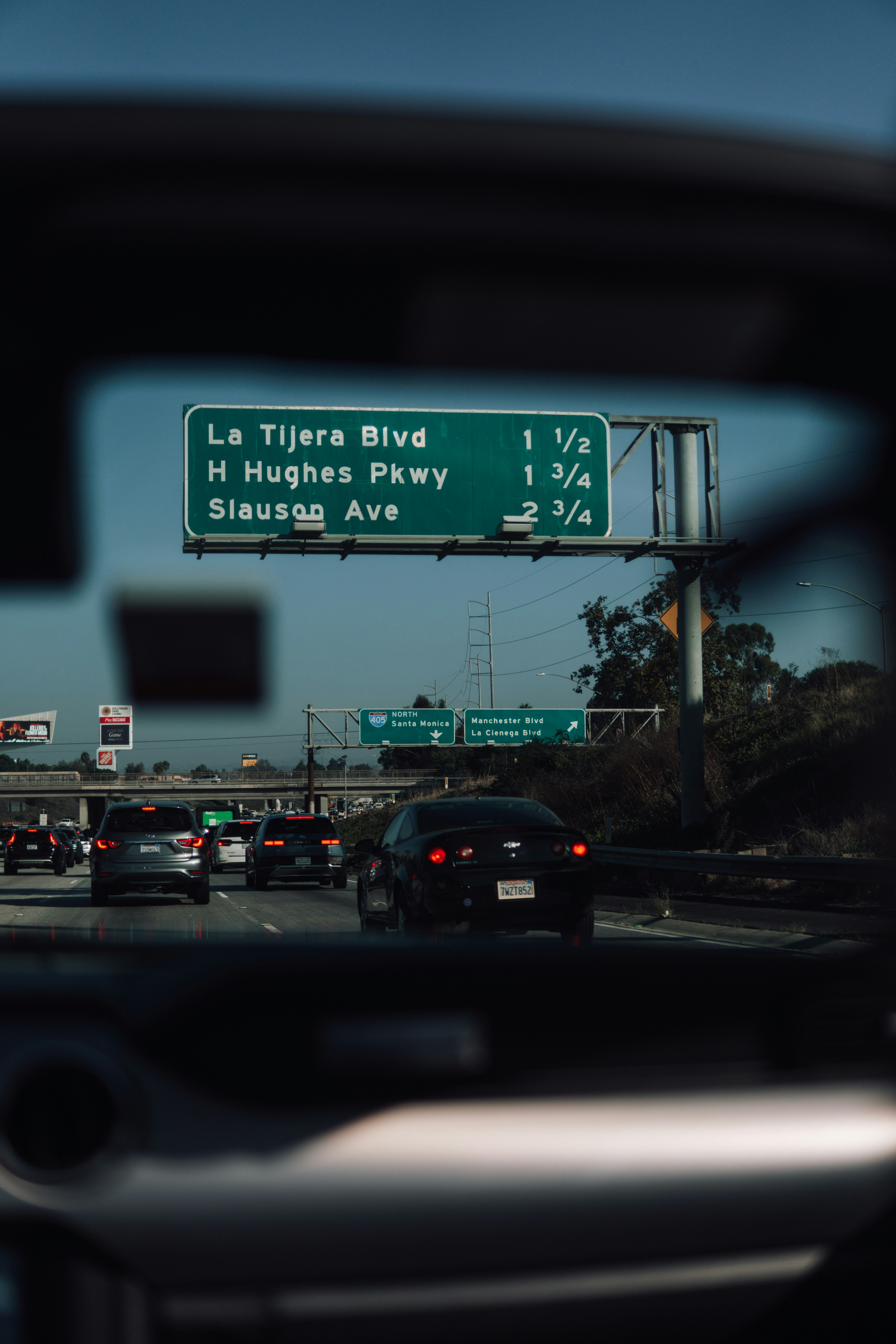 A view of a freeway sign from a car's side view mirror photo – Free ...