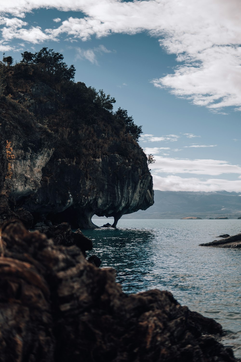 a large rock sticking out of the water