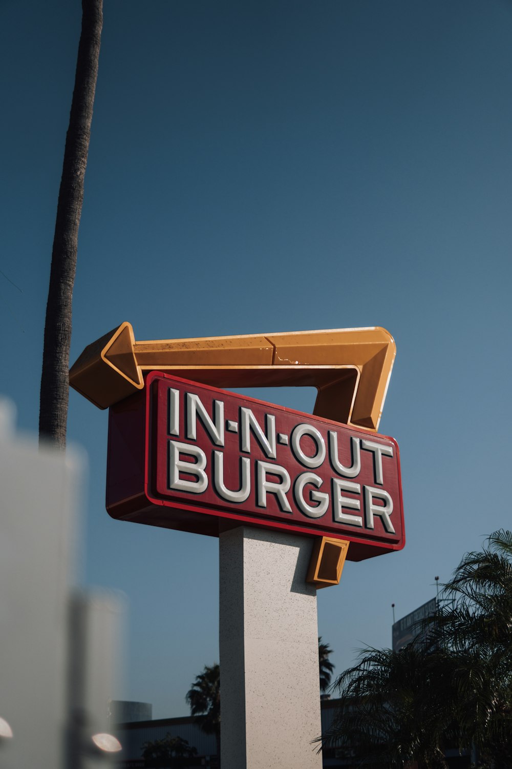 a red and white sign that says in - n - out burger
