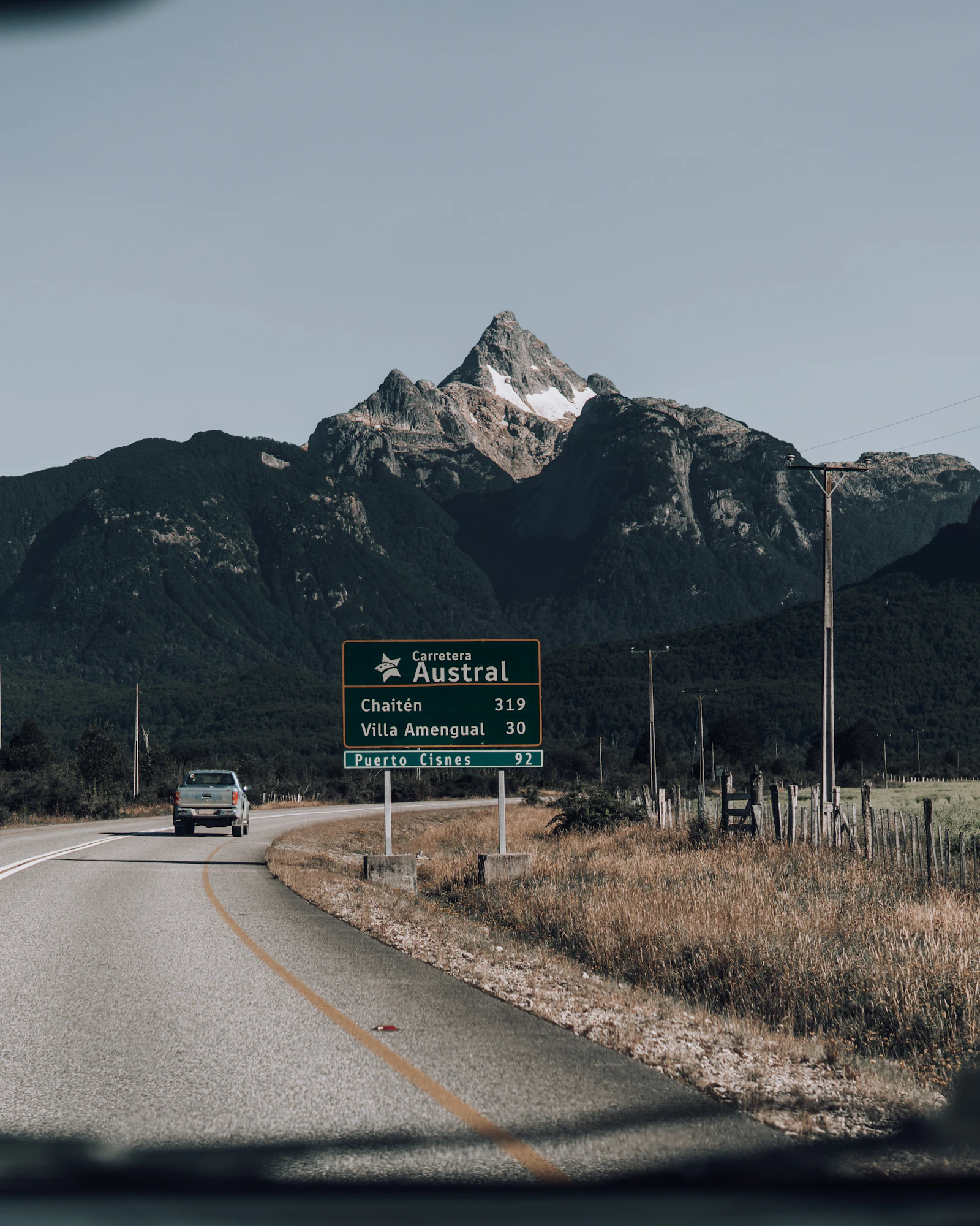 A car driving a remote mountain road on the Carretera Austral