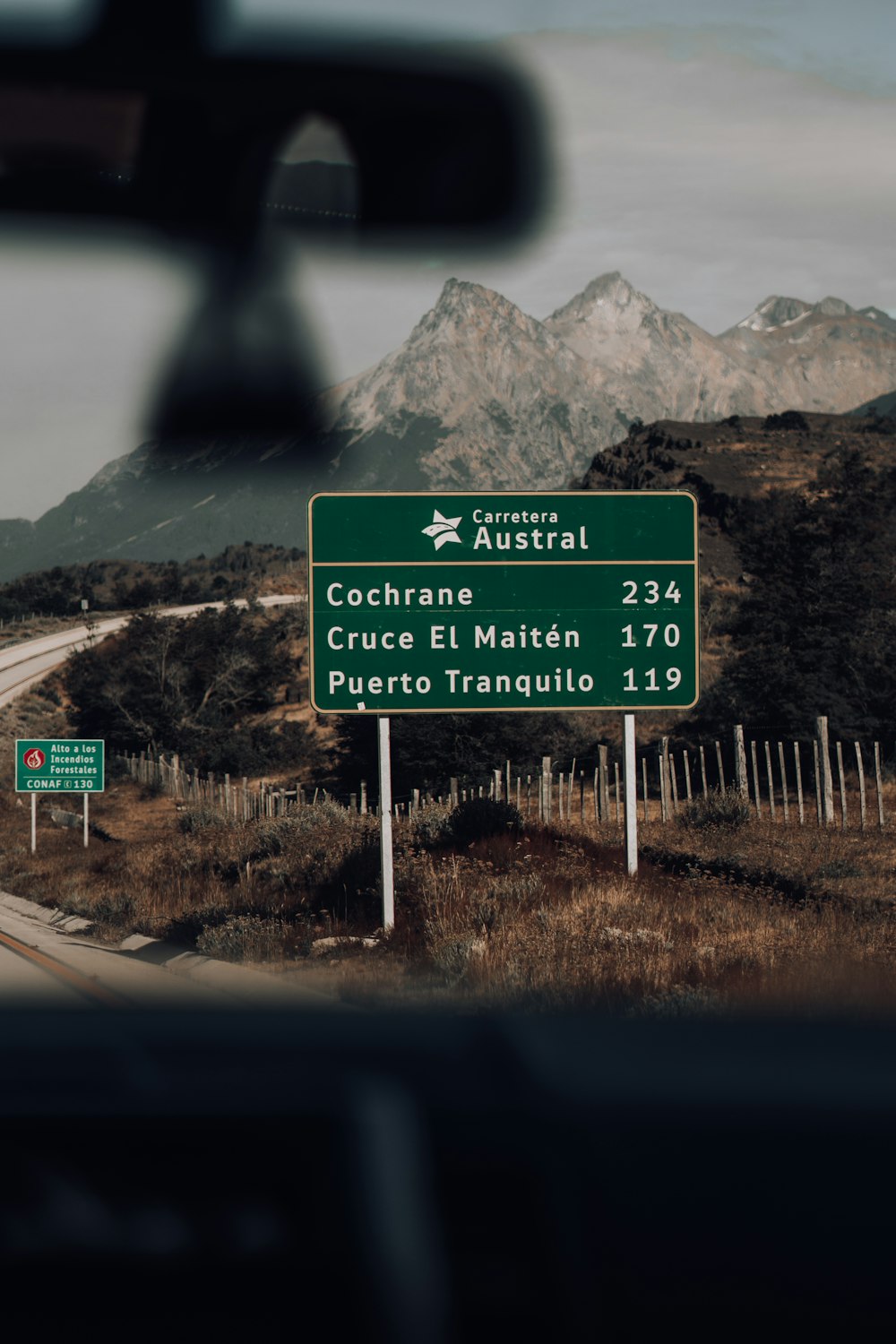 a view of a street sign from inside a vehicle