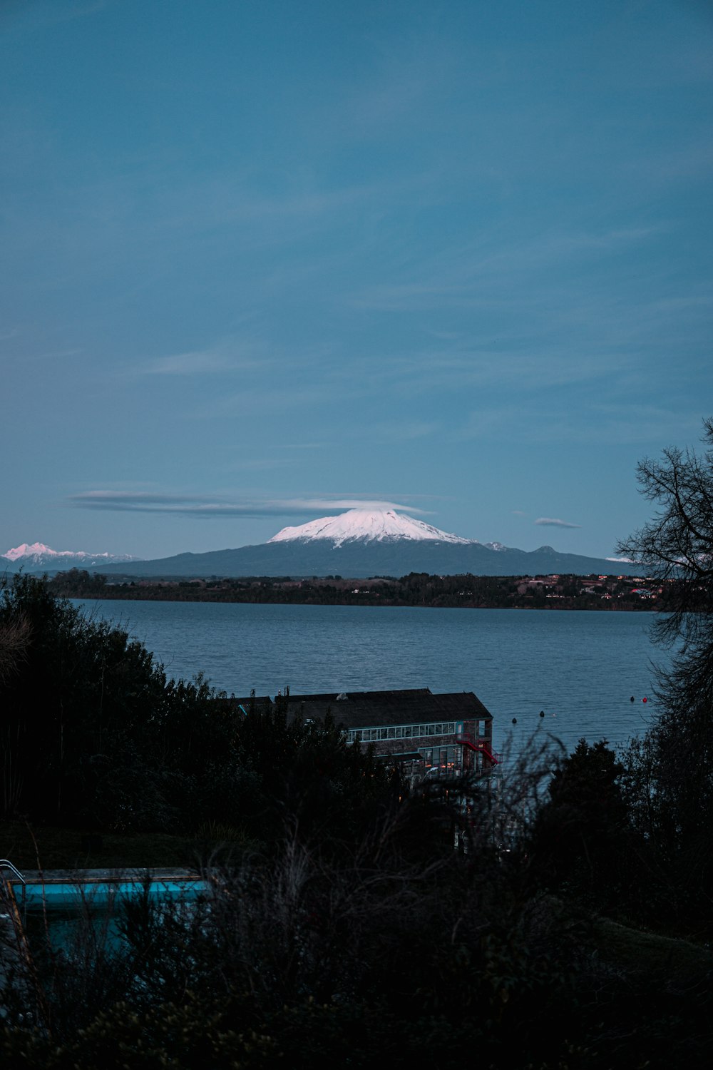 a body of water with a mountain in the background