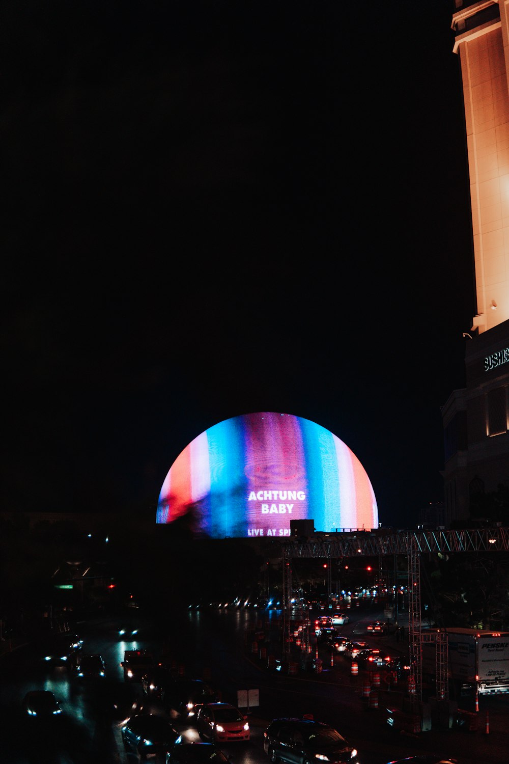 a large building with a colorful light on it's side