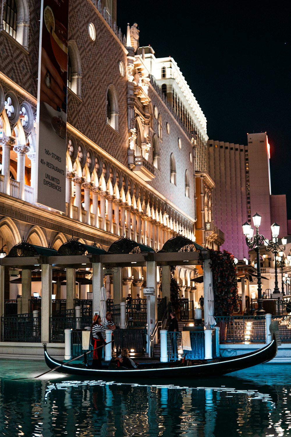 a gondola in front of a hotel at night