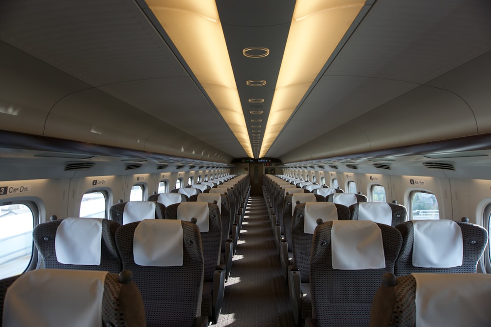 the inside of an airplane with rows of seats