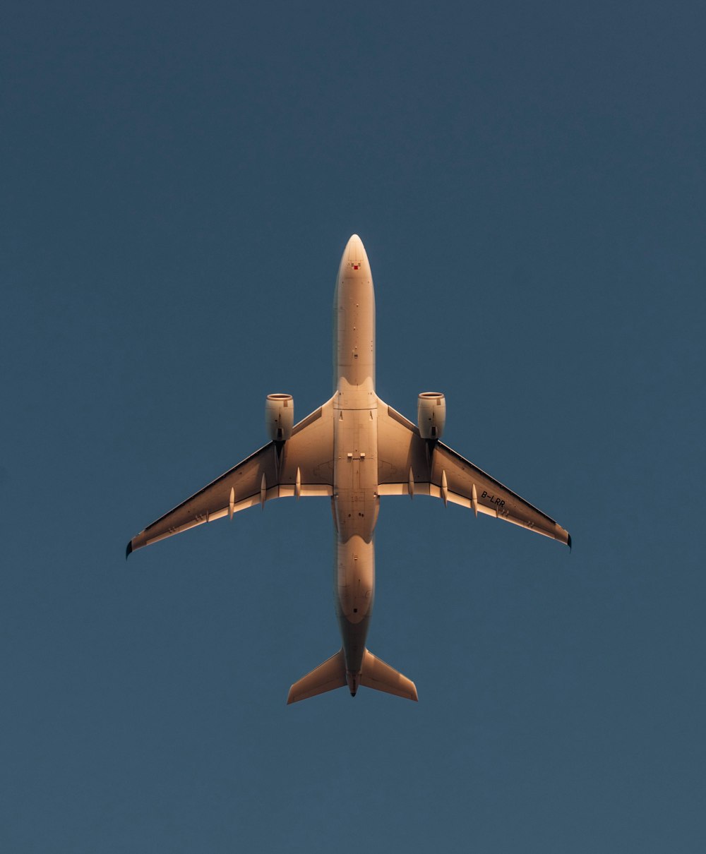 a large jetliner flying through a blue sky