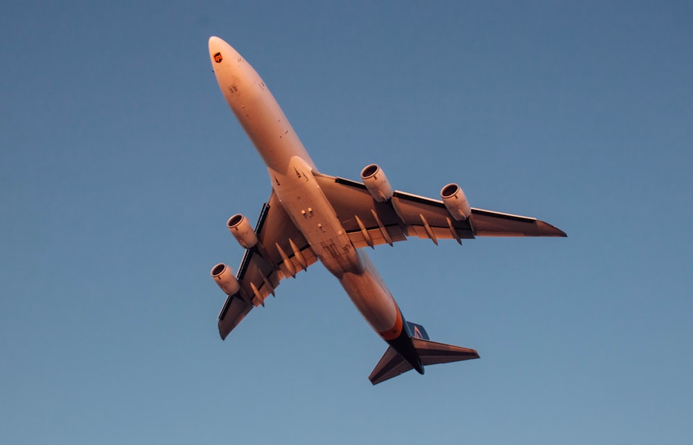 a large jetliner flying through a blue sky