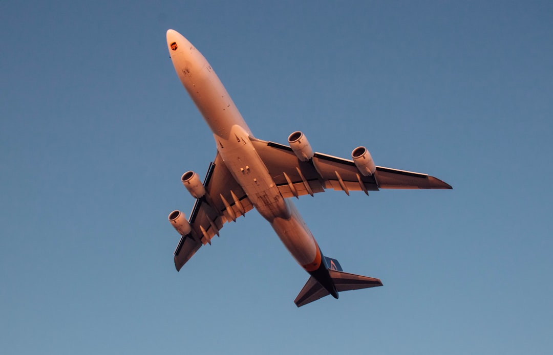 a large jetliner flying through a blue sky,