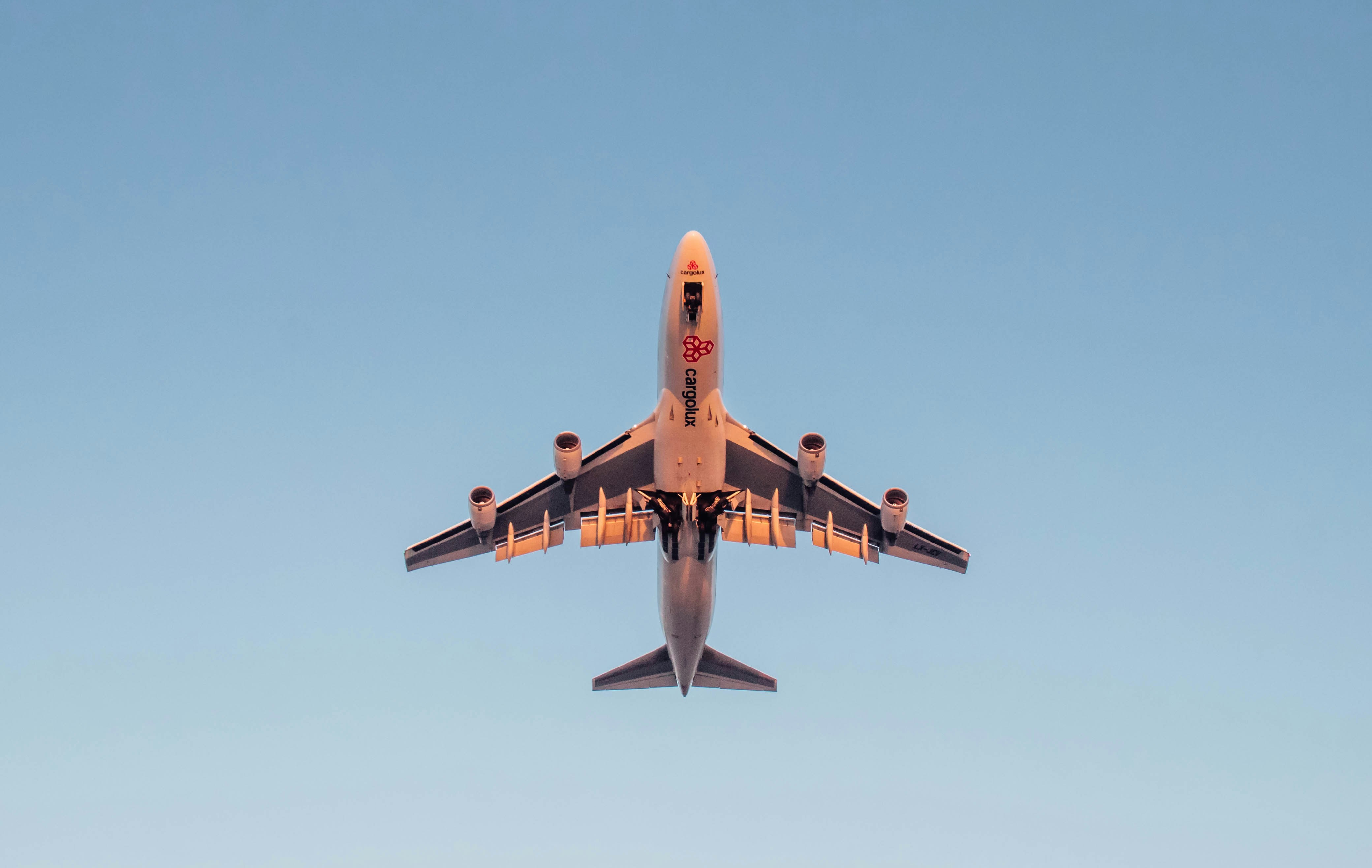 a large jetliner flying through a blue sky, 