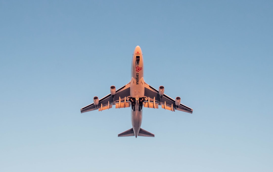 a large jetliner flying through a blue sky,