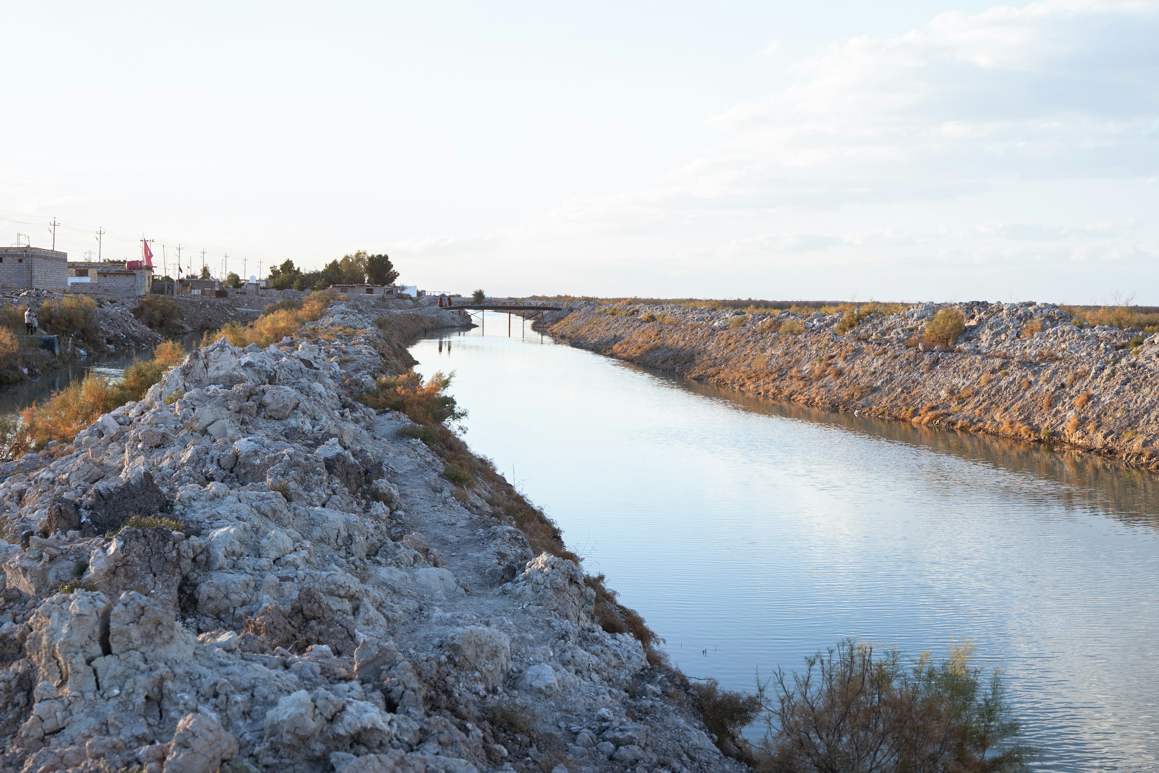 a large body of water next to a rocky shore