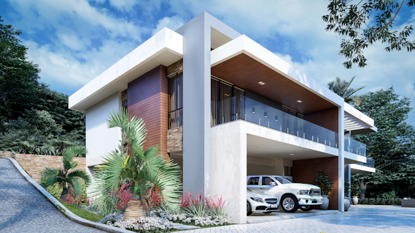 a white car is parked in front of a house
