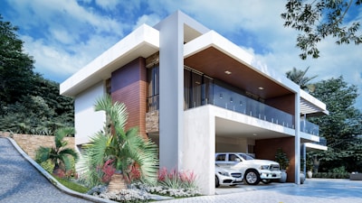 a white car is parked in front of a house