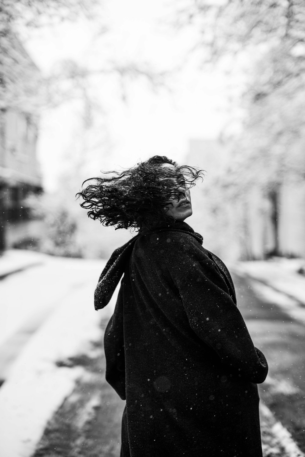 a woman walking down a snow covered street