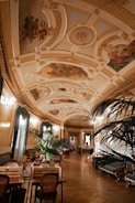 a large room with a ceiling painted with murals