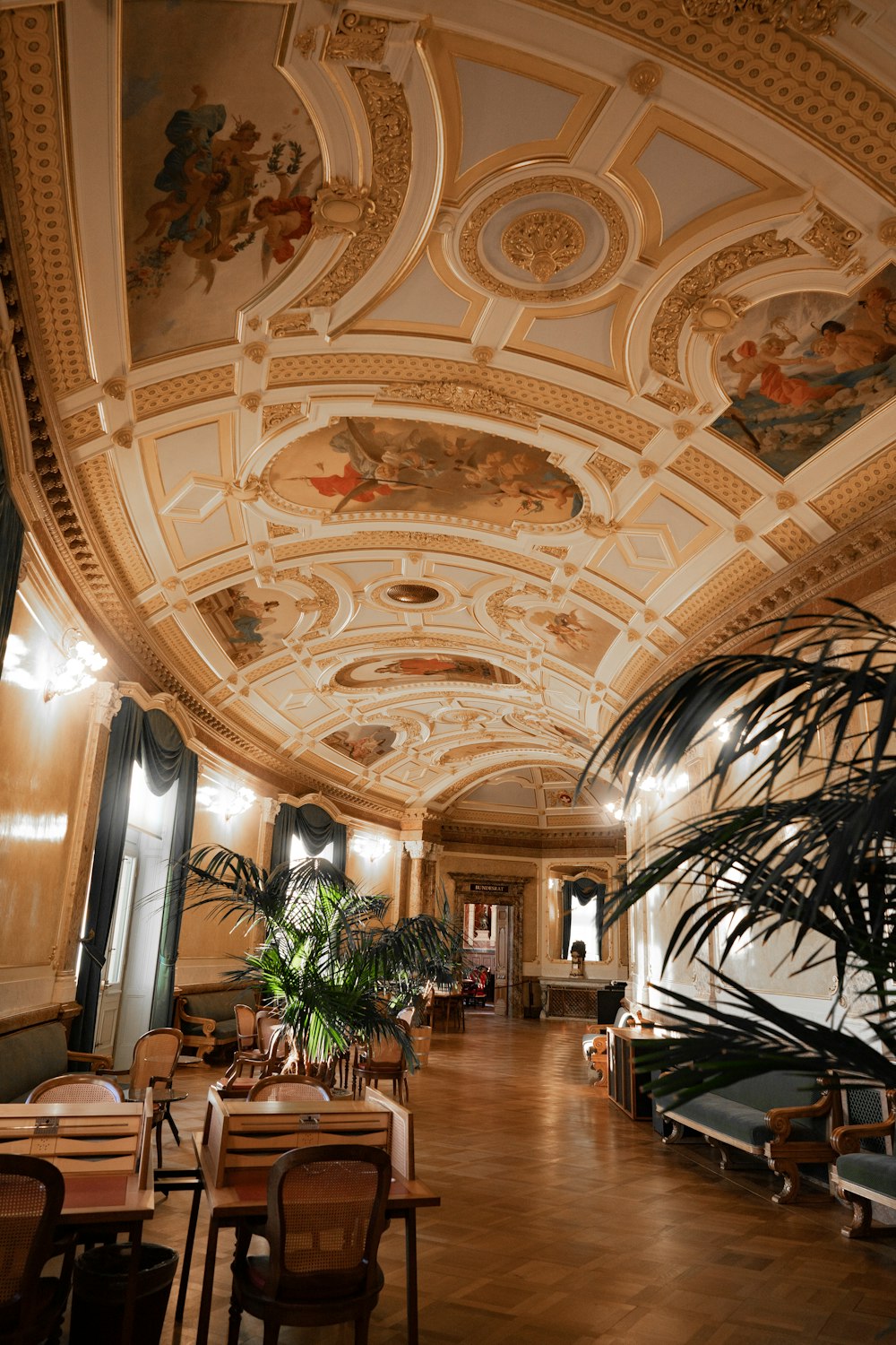 a large room with a ceiling painted with murals