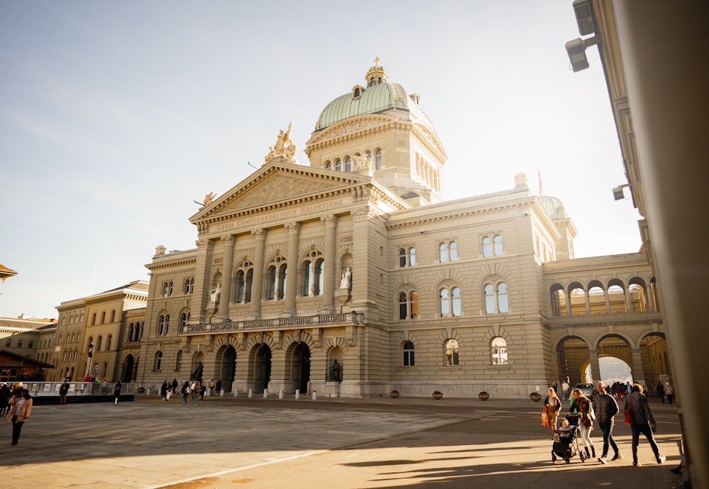 a group of people standing in front of a large building