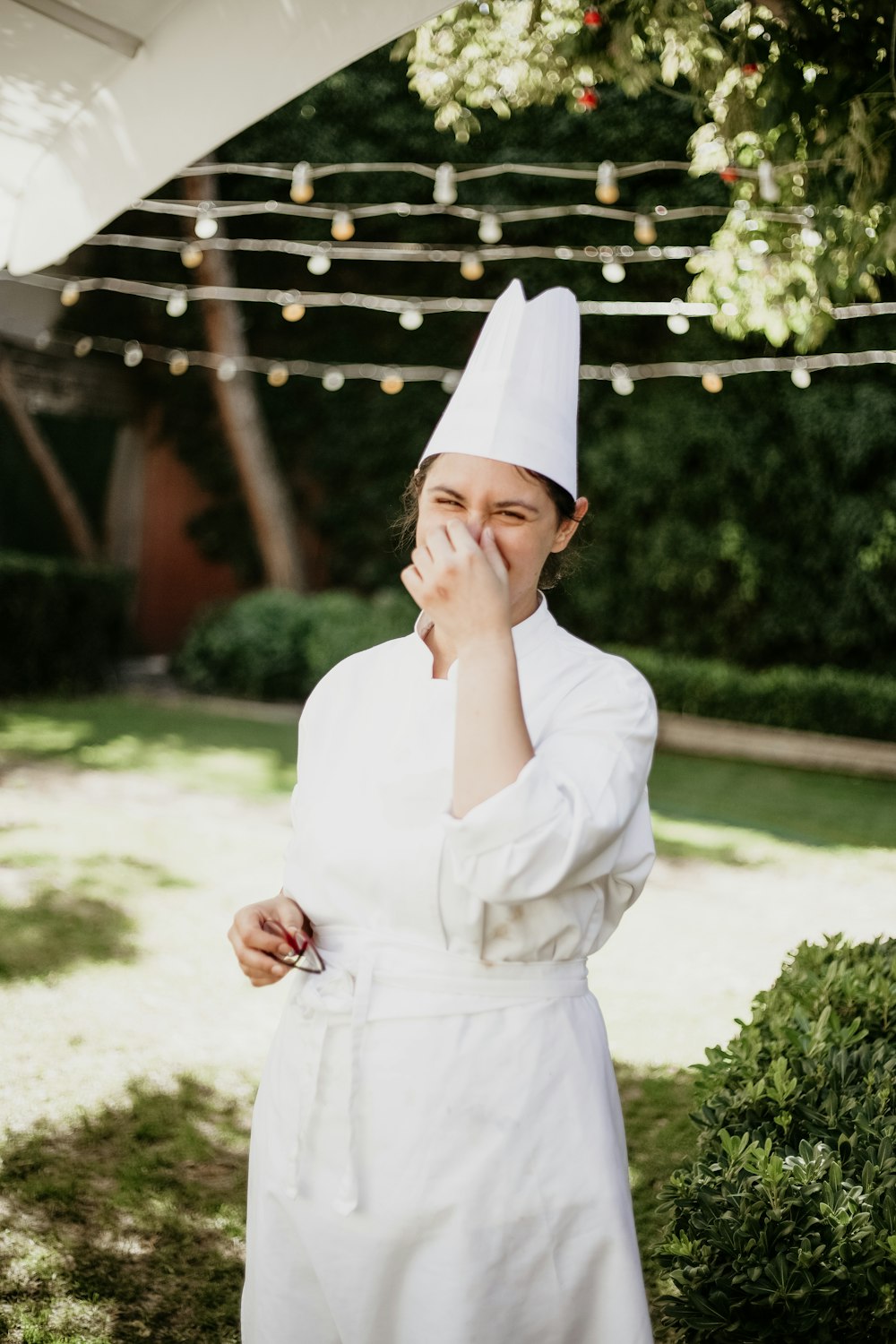 a woman dressed in a chef's outfit standing outside