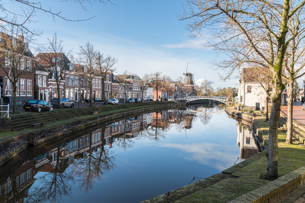 a river running through a small town next to a bridge