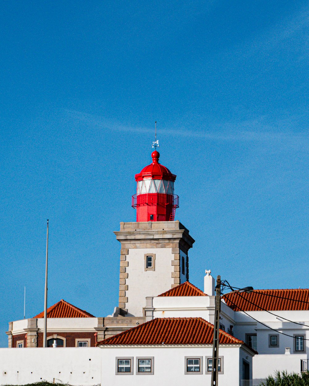 a red and white lighthouse on top of a building