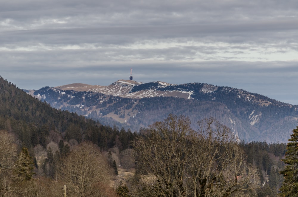 a view of a mountain with a tower in the distance