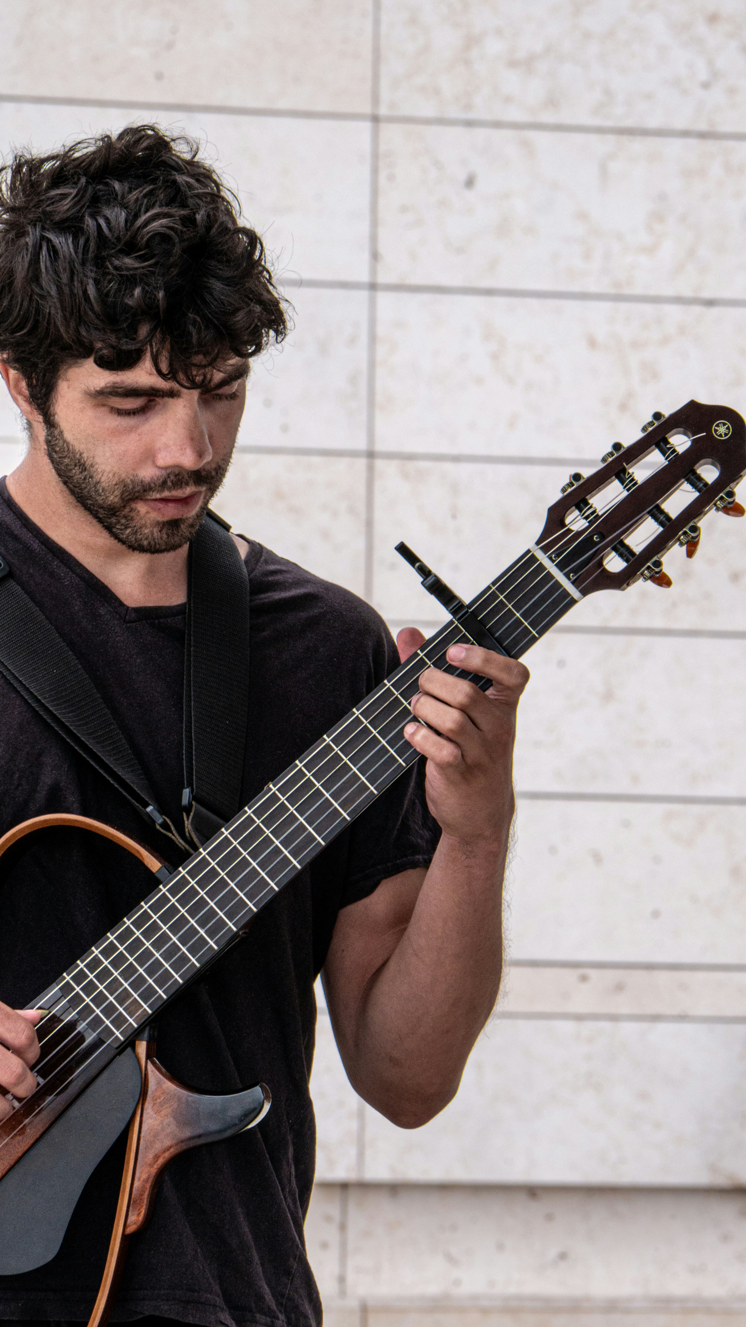 a man holding a guitar in his right hand