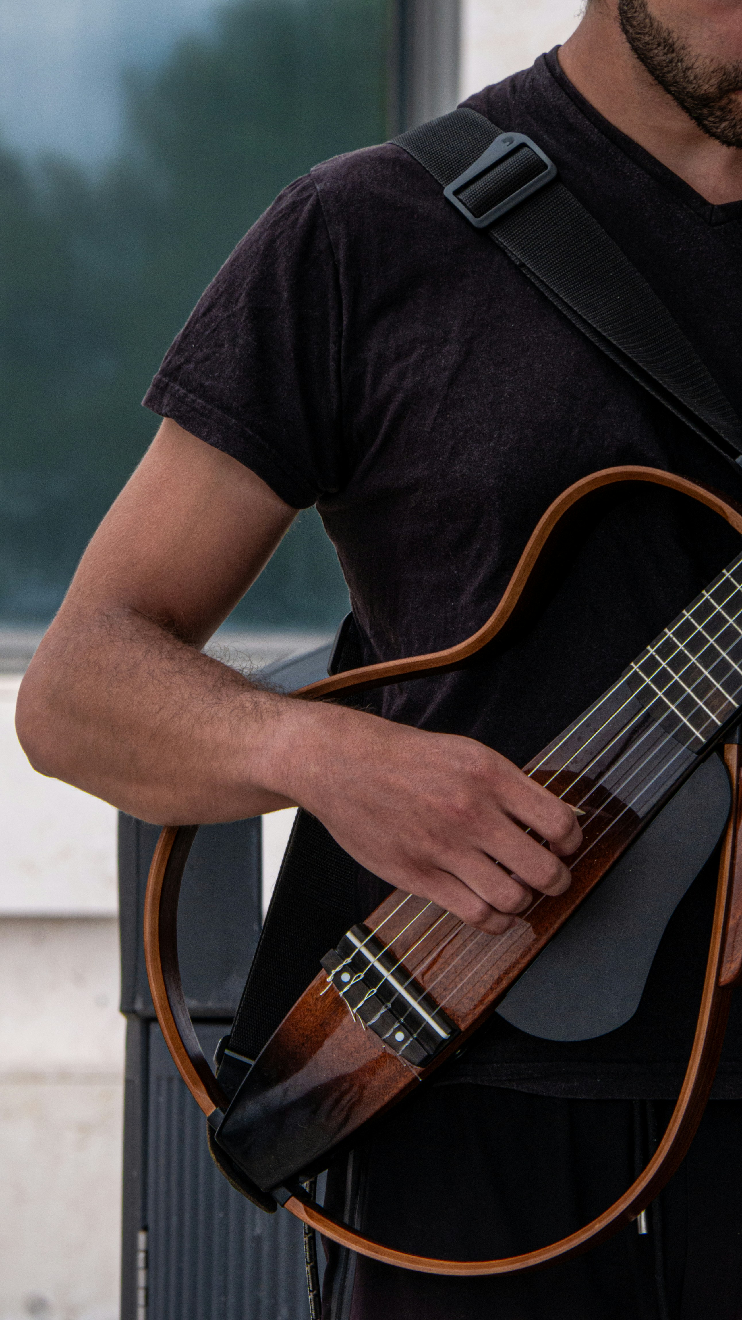 a man holding a guitar in his right hand