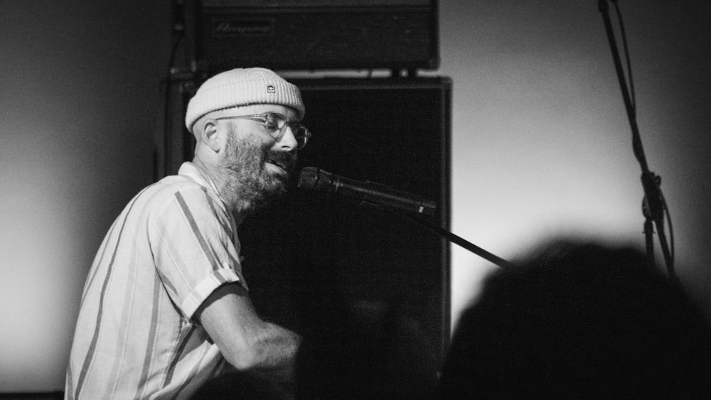 a man that is standing in front of a microphone