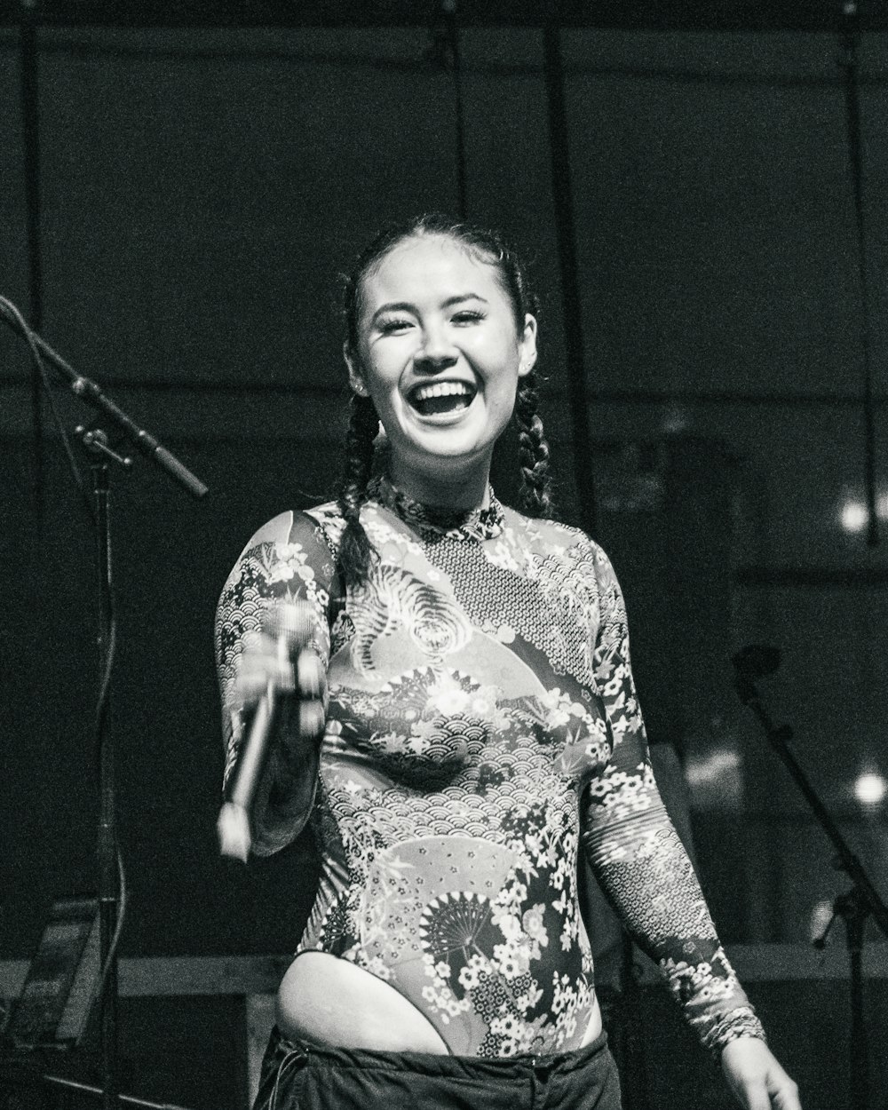 a woman standing in front of a microphone