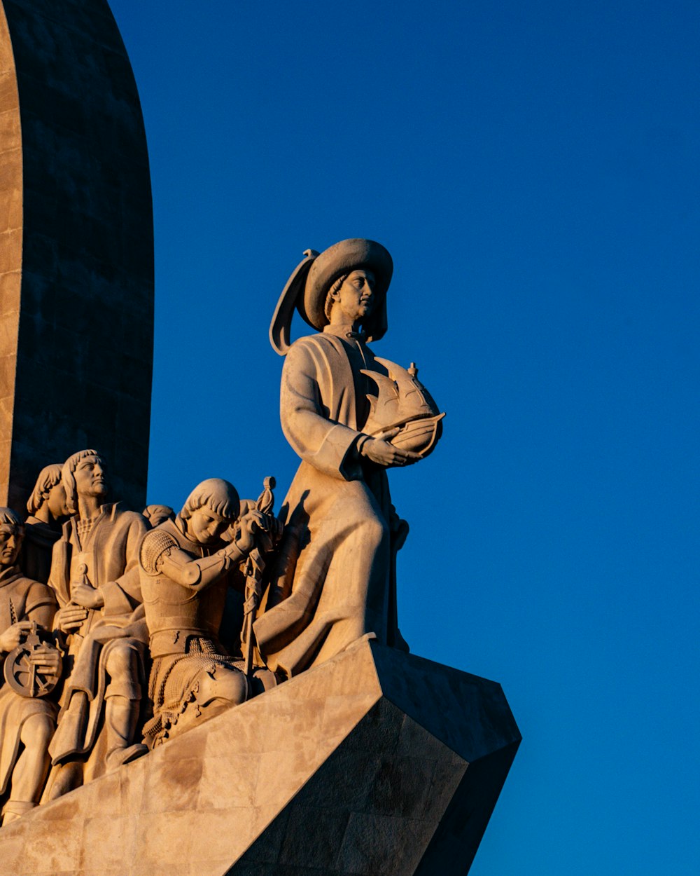 a statue of a woman holding a bowl of fruit