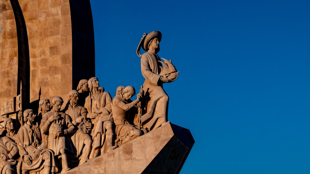 a statue of a woman with a hat on top of a building