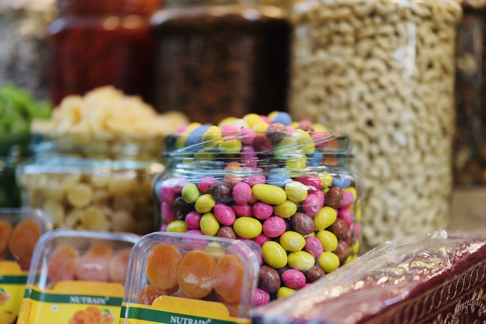 a variety of candies in a glass jar on a table