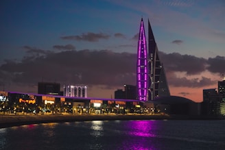 a very tall building with a purple light on it's side