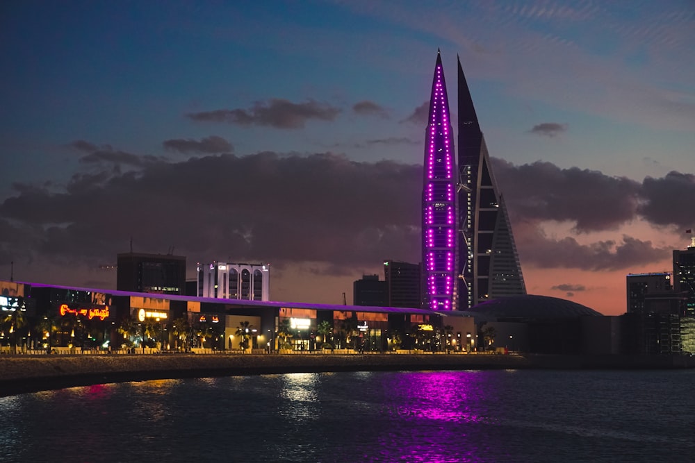 a very tall building with a purple light on it's side