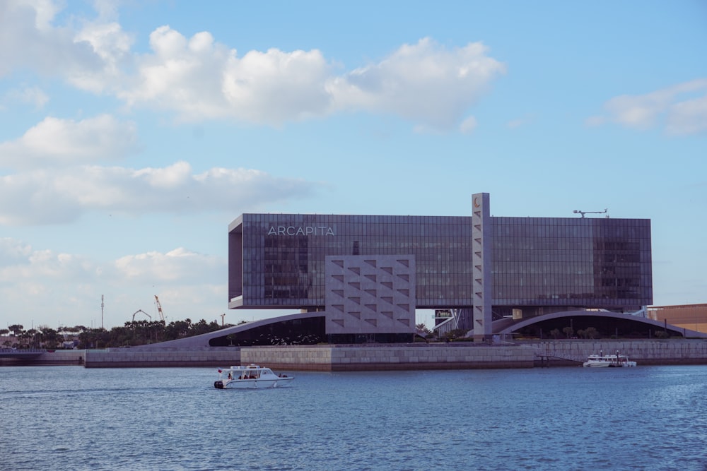 a large building sitting on the side of a river