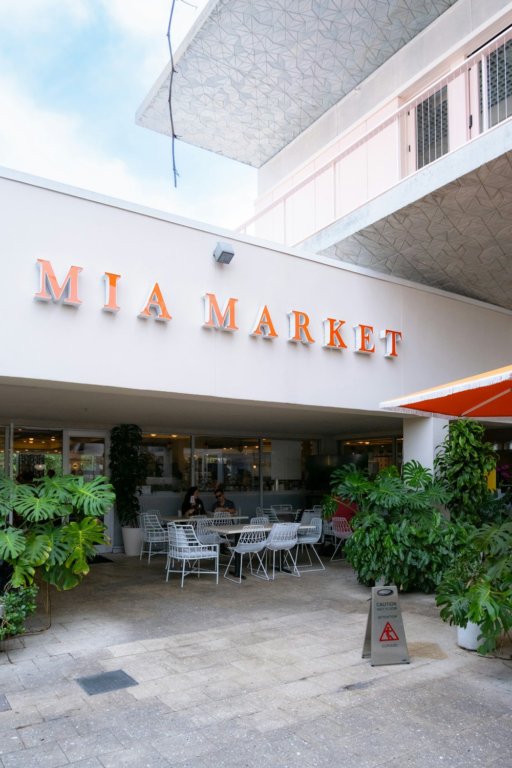 the entrance to a restaurant with tables and chairs