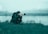 a photographer taking a picture of a body of water