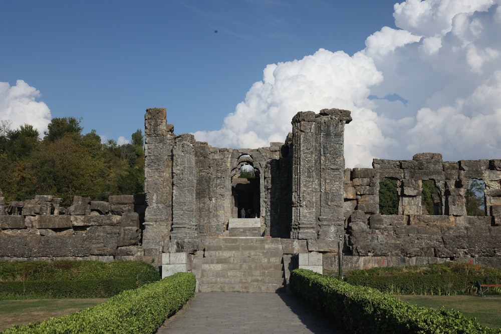 a stone building with a walkway leading to it